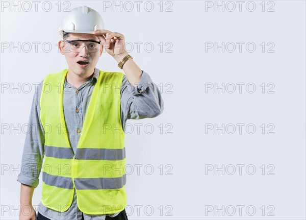 Amazed engineer looking into the distance isolated. Young engineer looking at something in the