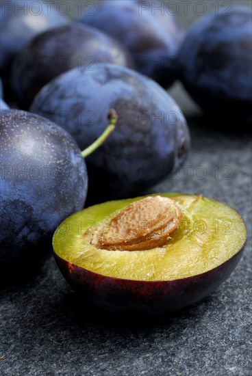 Plums (Prunus domestica) , plum, plum, plum, plum, halved