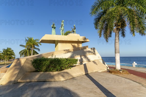 Artwork sculpture of priest with Spanish soldier and Mayan person, Malecon, Campeche city, Campeche