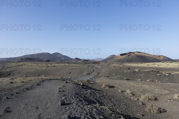 Path through the volcanic landscape to the Caldera de Los Cuervos volcano, Tias, Lanzarote, Canary
