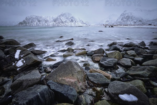 Waves and rocks on coast of Norwegian sea in fjord. Skagsanden beach, Flakstad, Lofoten islands,
