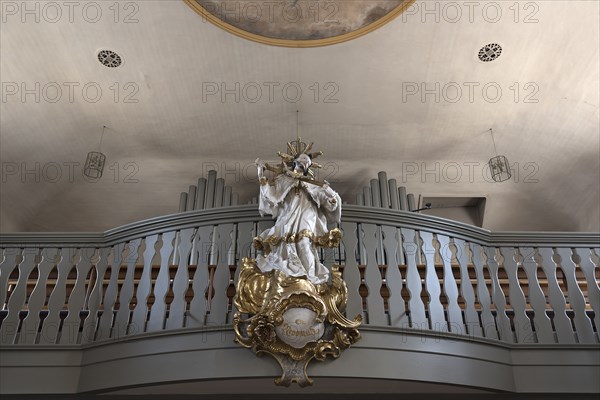 Figure of St. Nepomuk in front of the organ loft in the parish church of St. James the Elder, built