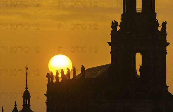 Sunset in Dresden. The sun disc, particularly orange due to the Sahara dust, sets behind the