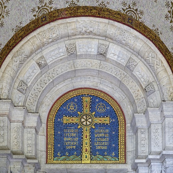 Cross mosaic in the tympanum with the quotation Eine feste Burg ist unser Glauben by Martin Luther,