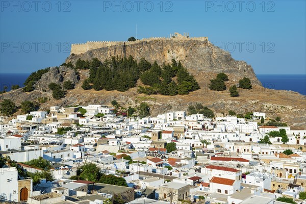 Town of Lindos with white houses, Acropolis of Lindos in the back, Lindos, Rhodes, Dodecanese,