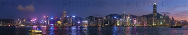 Panorama of Hong Kong skyline cityscape downtown skyscrapers over Victoria Harbour in the evening