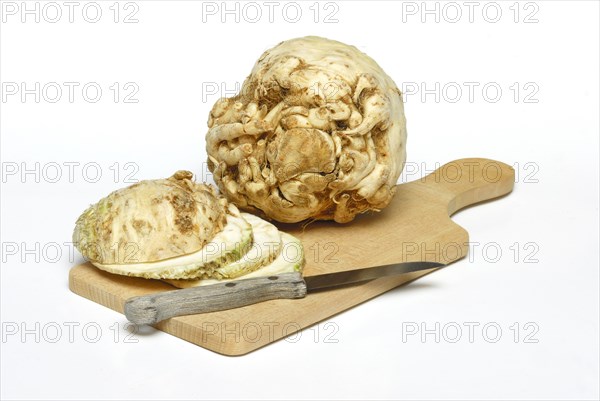 Celery (Apium graveolens) tubers and s lices, knives
