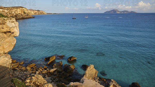 Rocky coast, sailing boats, Levanzo Island, Scogliera di Cala Rossa, Cala Rossa, Favignana, Egadi