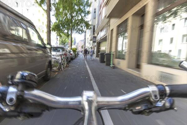 Cycling from a first-person perspective on a cycle path in Cologne, North Rhine-Westphalia,