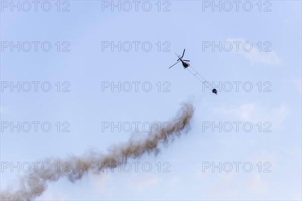 Symbolic image, climate change, helicopter, helicopter spreading finely painted limestone and ash