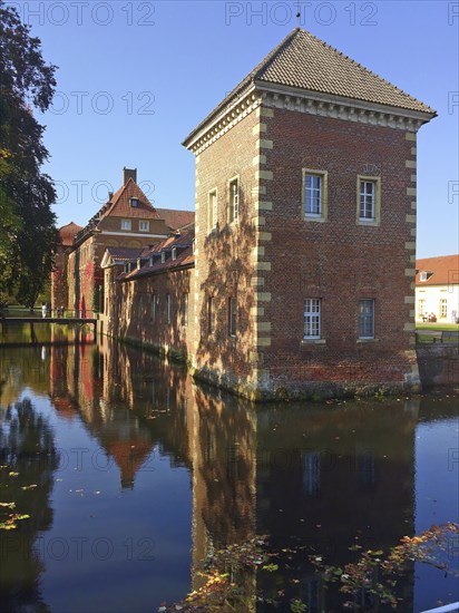 Reflection of tower standing in moat of Westphalian moated castle Schloss Velen, Velen,
