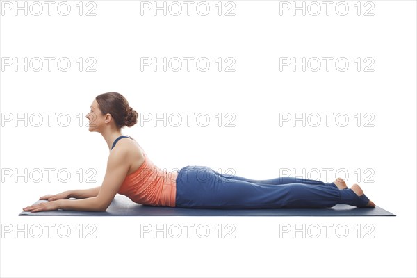 Beautiful sporty fit yogini woman practices yoga asana salamba bhujangasana, sphinx pose beginnner