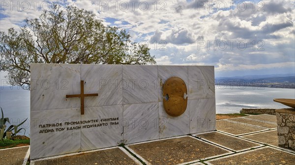 HDR, war memorial to Greek cadets of WW2, marble slab, cloudy dramatic sky, east coast of Rodopou