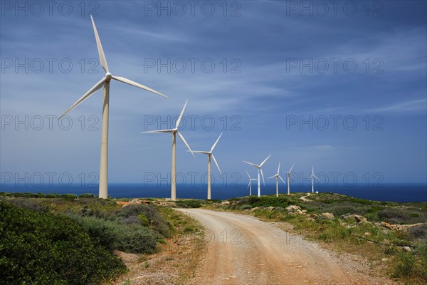 Green renewable alternative energy concept, wind generator turbines generating electricity. Wind