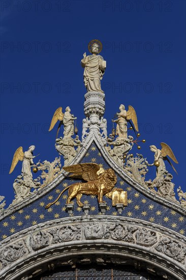 Sculptures and St. Mark's lion on the facade of St. Mark's Cathedral, Venice, San Marco district,