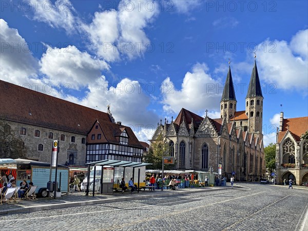 Historic market square scene with Gothic buildings and people under a blue sky with clouds, Market,