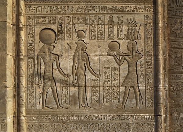 Hieroglyphic carvings on the exterior walls of an ancient egyptian temple