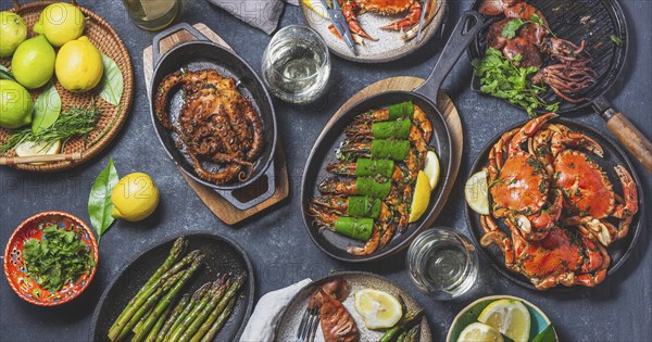 Food Photography, Set table with seafood dishes, cooked crabs, tiger shrimps, grilled octopus and