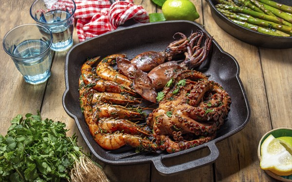 Food Photography, Grilled spimps, squids and octopus in cast iron grill pan
