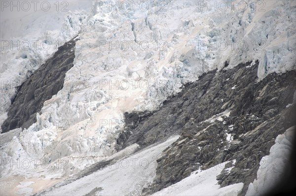 Franz Josef Glacier, Westland, New Zealand. Brown discolouration on the snow is smoke from