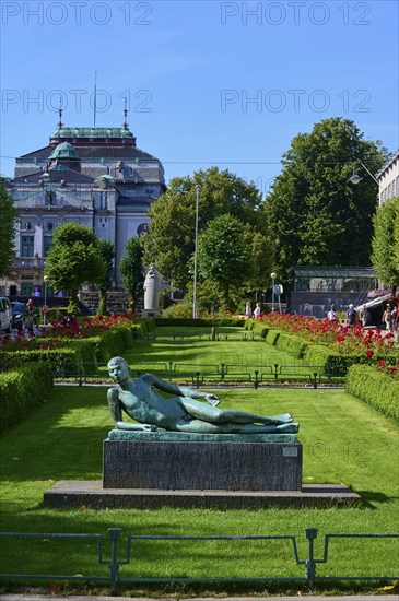 Lying poet statue in front of a historic building and sunny weather, Bergen, Vestland, Norway,
