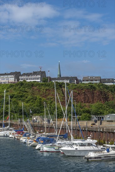Sailing yachts in the north-east harbour, Buntsandstein cliff, Helgoländer Oberland with church