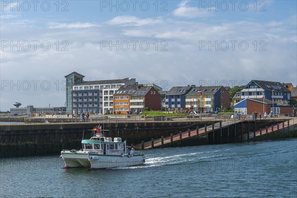 View of the Helgpländer Unterland on the north-east harbour with departing boat of the island tour,