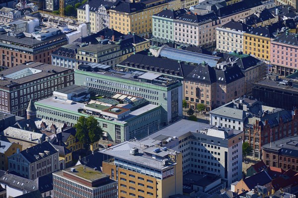 Aerial view of a city with densely packed buildings in different colours and styles, urban