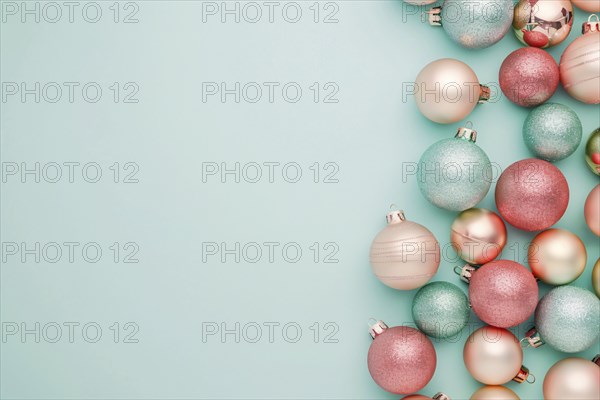 Christmas flatlay with blue and pink colored tree baubles on pastel background with copy space.