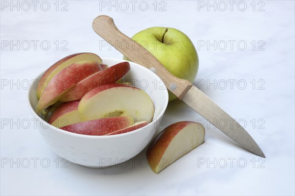 Apple and apple slices in peel, sliced apple with knife