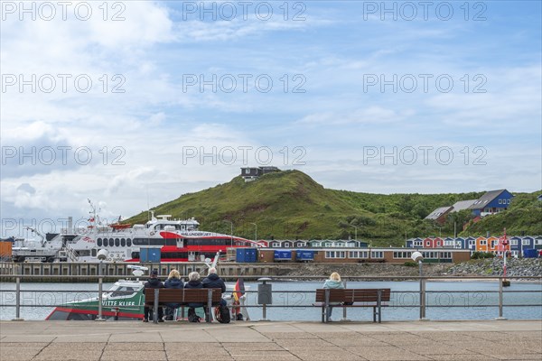 View over the jetty to the high-speed catamaran Halunder Jet, colourful lobster shacks, midland