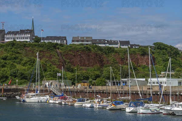 Sailing yachts in the north-east harbour, Buntsandstein cliff, Helgoländer Oberland with church