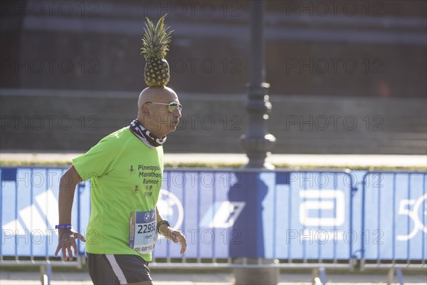 Pineapple Marathon Runner (Moshe Lederfein) balances a pineapple on his head during the run at the