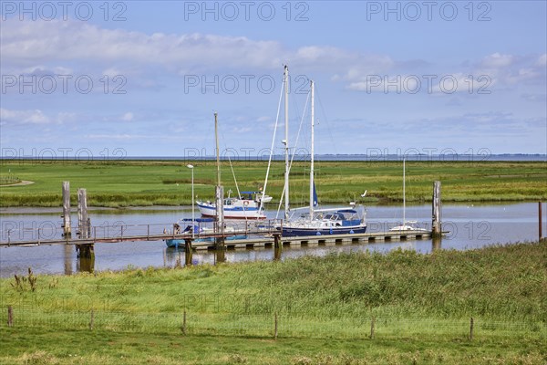 Sailing boats at the entrance to Varel harbour and dyke foreland in the town of Varel, district of