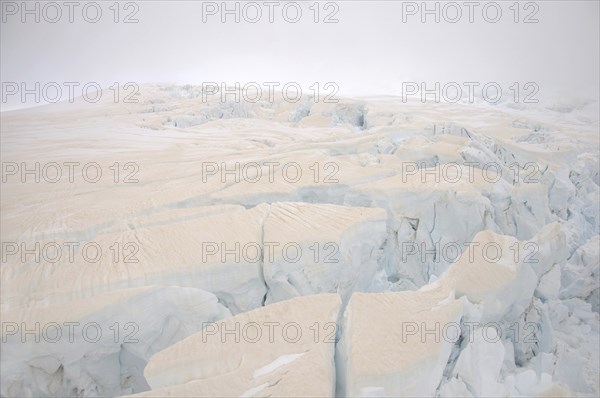 Franz Josef Glacier, Westland, New Zealand. Brown discolouration on the snow is smoke from