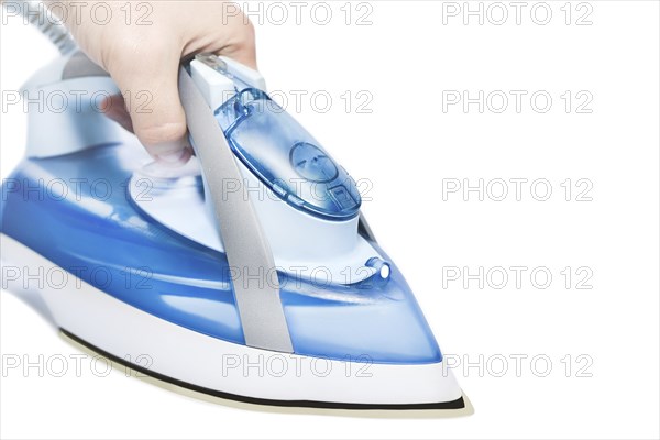 Hand of a man holding an iron on a white background isolated. close up