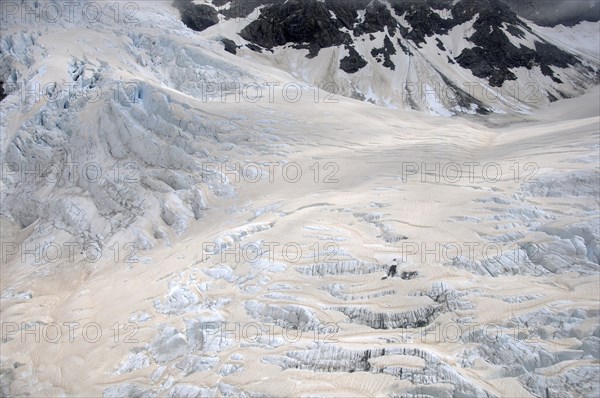 Franz Josef Glacier, Westland, New Zealand. Brown discolouration on the snow is smoke from