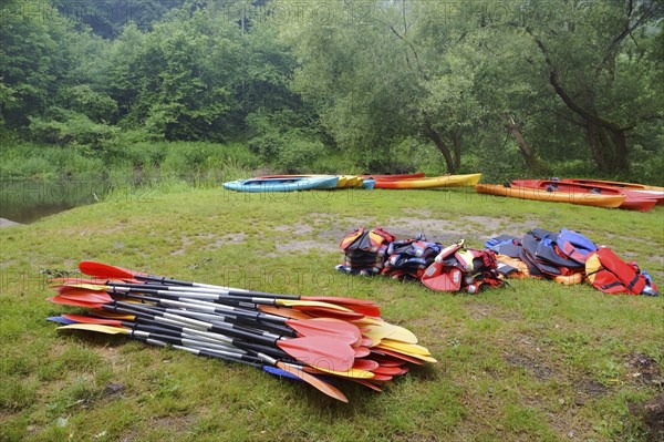 The oars from the canoes on the shore, preparing for the Canoeing