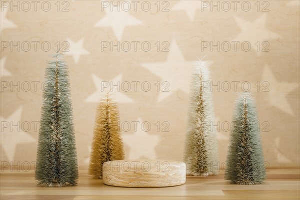 Wooden podium pedestal product mockup display with miniature Christmas trees in beige and green, 3d