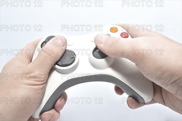 Joystick gamepad in the player's hands isolated on white background