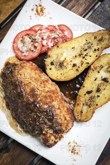 Chicken schnitzel with potato and gravy simple meal