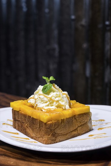 Gourmet fusion french toast with mango and whipped cream