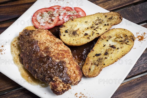 Chicken schnitzel with potato and gravy simple meal