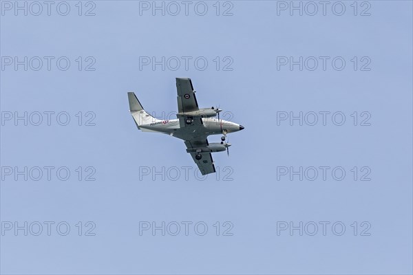 Twin-engine naval aircraft flies over beach, Westende, Middelkerke, Belgium, Europe