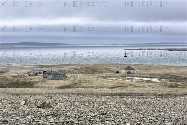 Wooden shacks and cabins at deserted 1950s Kinnvika Arctic research station, Murchisonfjord,
