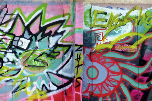 Colourful graffiti artworks cover two walls, showing abstract shapes and tags in an urban