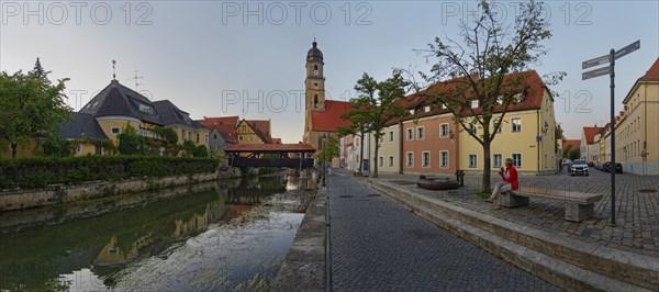Panorama of the river Vils with the spire of St Martin's Basilica and the historic ship bridge at