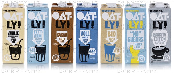 Oatly different types of vegan oat milk cropped against a white background