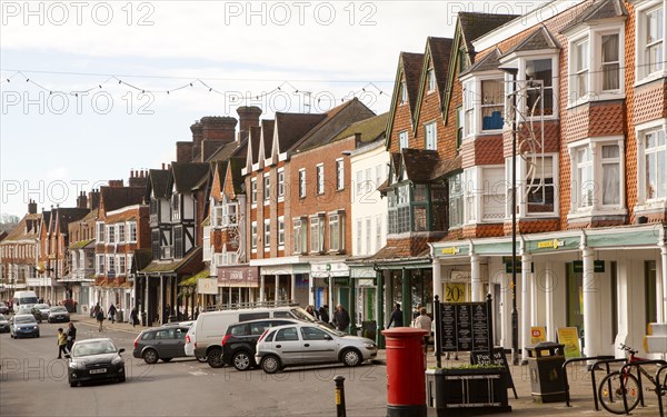 People shopping on historic High Street of Marlborough, Wiltshire, England, UK