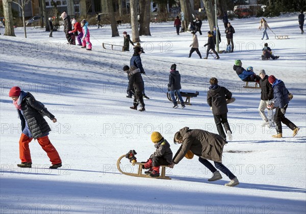 Tobogganing fun in Berlin's snow-covered Viktoriapark. Snow and icy cold continue to dominate the